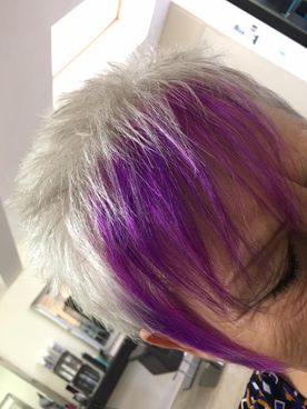 A woman that has had her fringe dyed purple